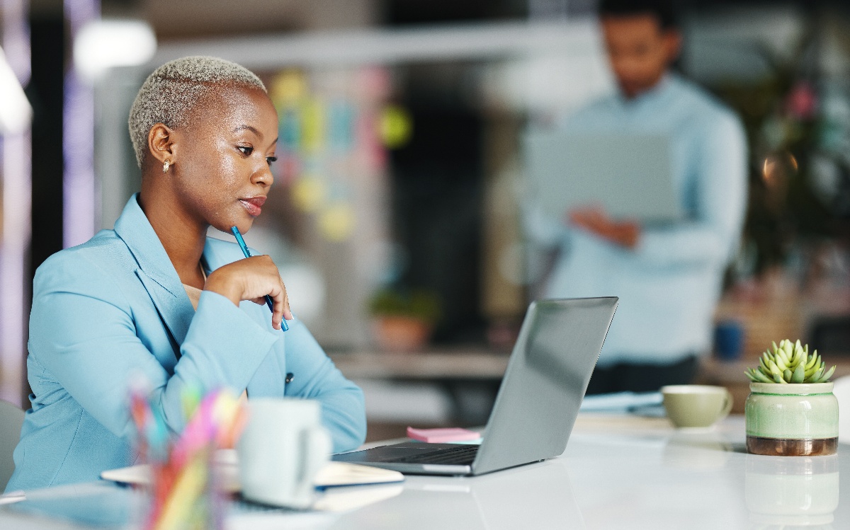 A business woman uses a laptop to review healthcare options.