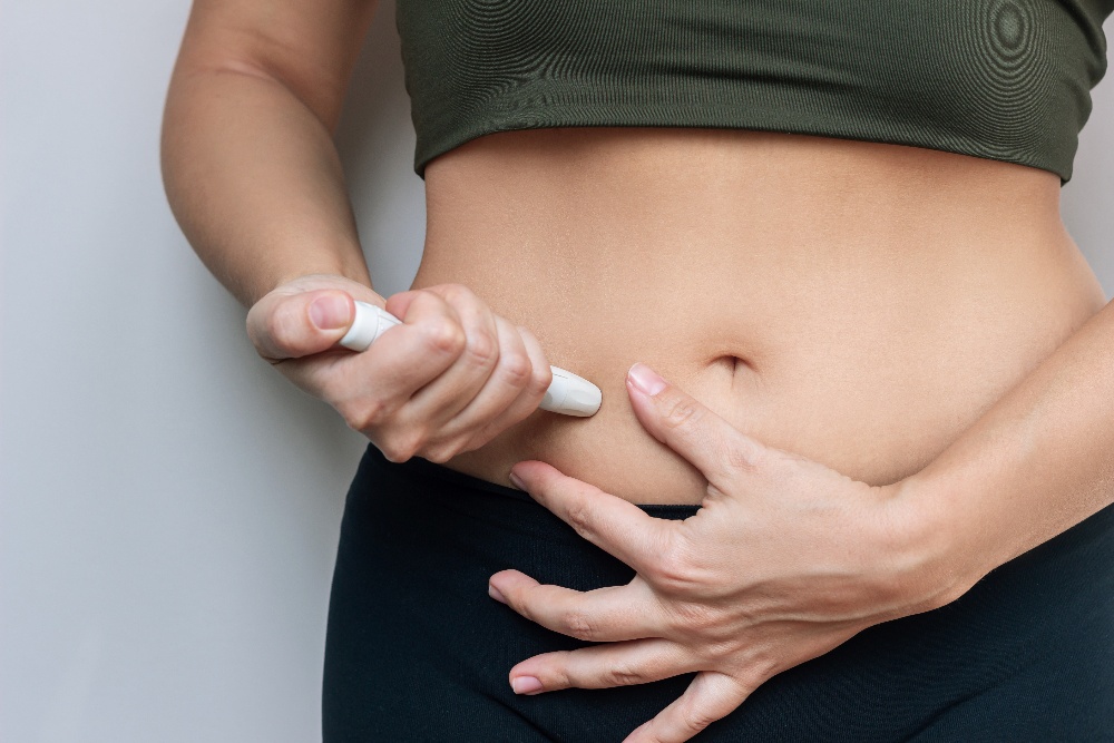 A female patient using a GLP-1 weight loss drug. 